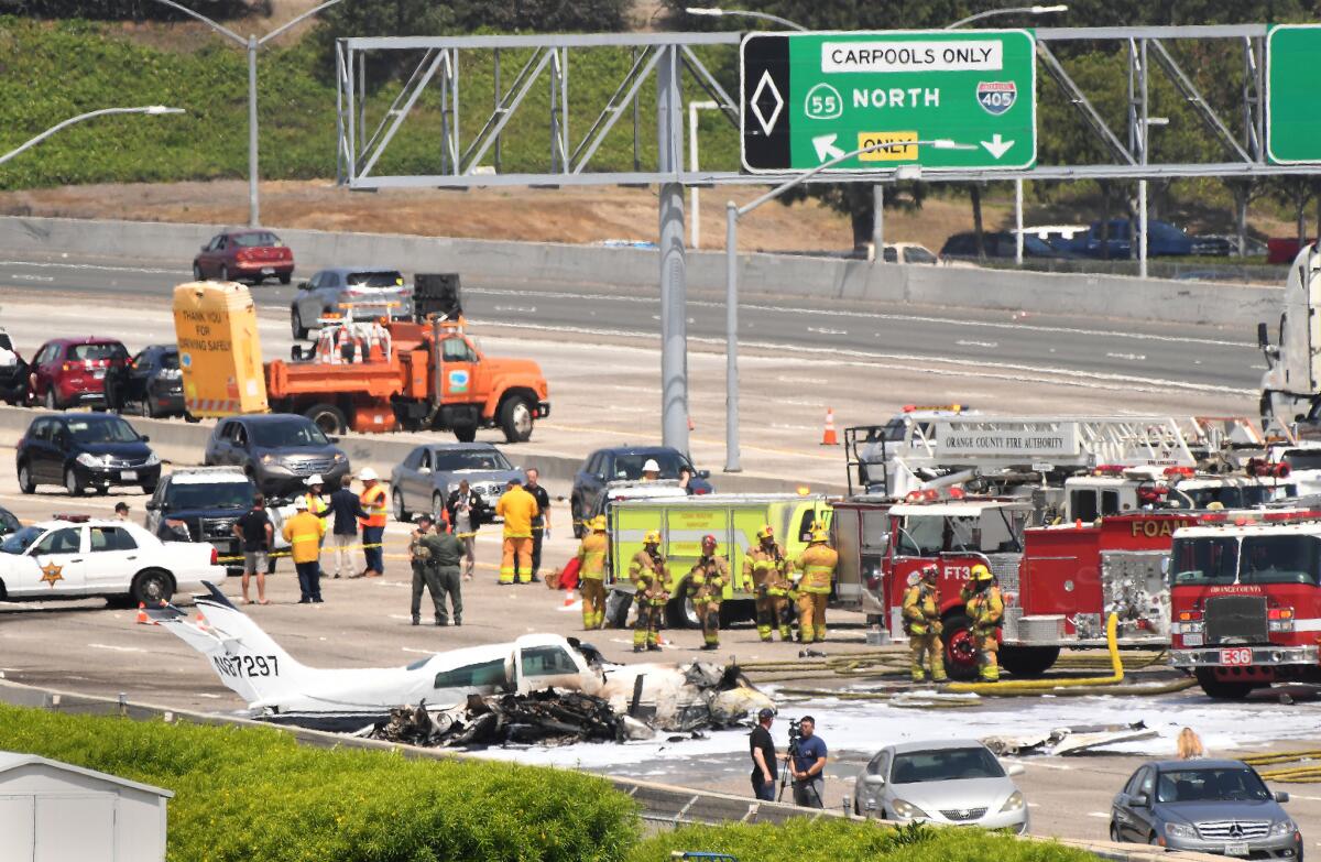 The wreckage of a small plane sits on the southbound 405 Freeway after a crash just short of the John Wayne Airport runway.