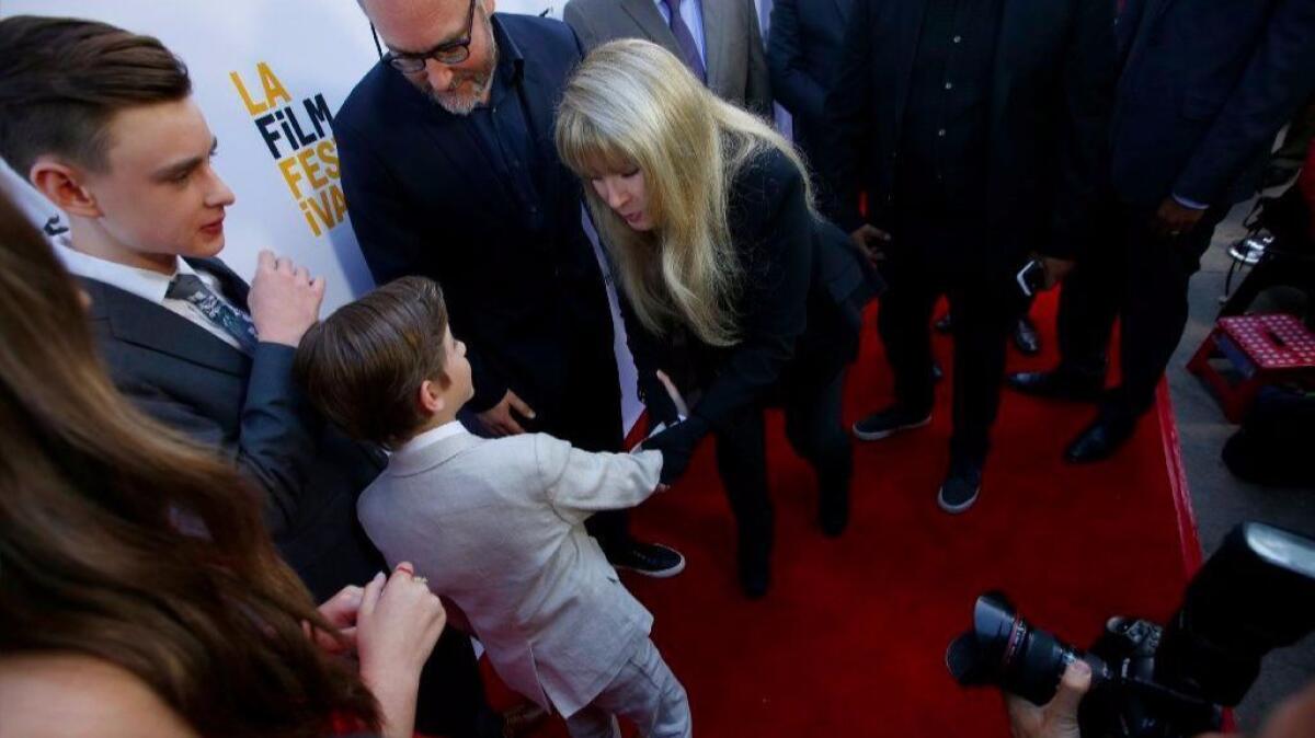 Jacob Tremblay shakes Stevie Nicks' hand on the red carpet.