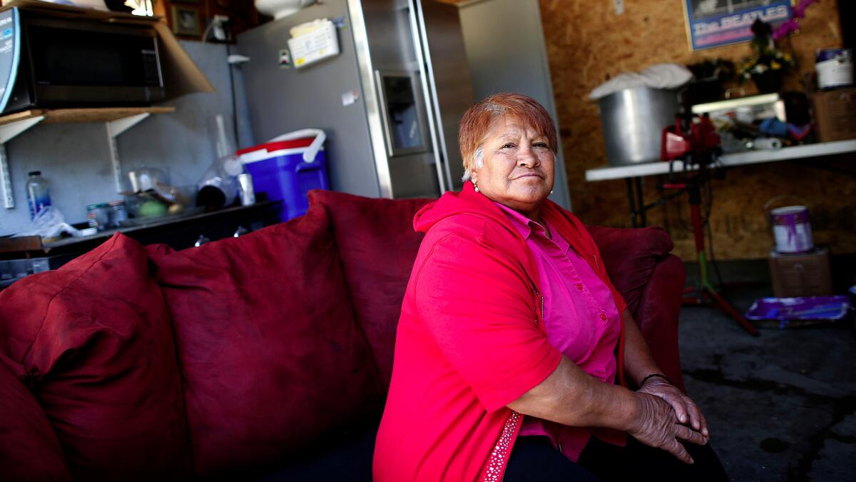 Laura Luevano is one of thousands of L.A. County residents with government-backed rent vouchers who can't find a place to live. She sleeps on a couch on the back patio of a house in Sylmar.