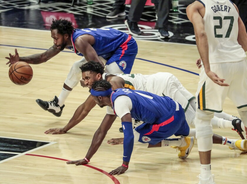 Clippers guard Reggie Jackson is fouled by Utah Jazz guard Donovan Mitchell.