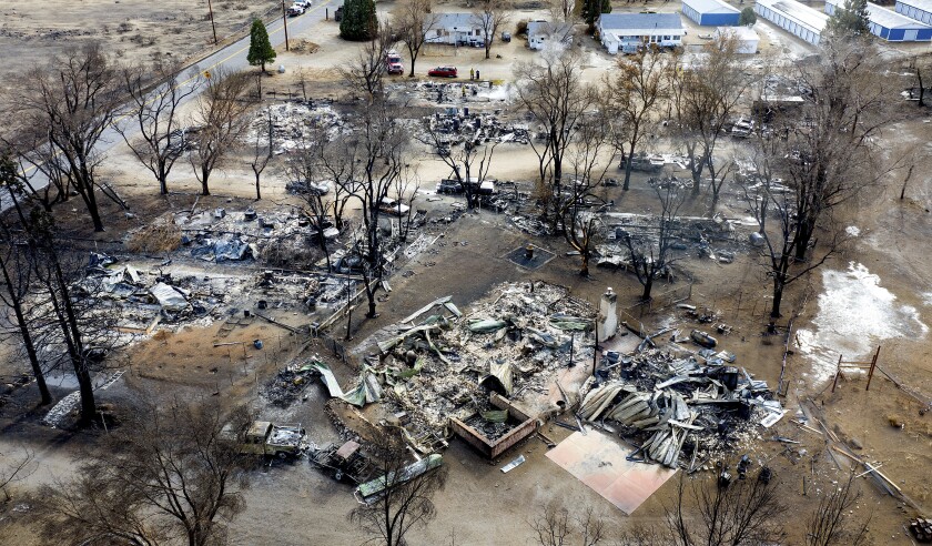 FILE - In this Nov. 18, 2020 file photo taken by a drone, residences destroyed by the Mountain View Fire line a street in the Walker community in Mono County, Calif. As consecutive years of catastrophic wildfires drive up the cost of insuring homes across California, state regulators announced on Monday, Feb. 8, 2021, a step toward creating incentives for retrofitting older homes to make them more resilient to fires. (AP Photo/Noah Berger, File)