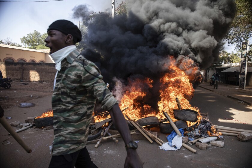 Protestors take to the streets of Burkina Faso's capital Ouagadougou Saturday Nov. 27, 2021, calling for President Roch Marc Christian Kabore to resign. The protest comes after the deadliest attack in years against the security forces in the Sahel's Soum province earlier this month, where more than 50 security forces were killed and after an attack in the Center North region where 19 people including nine members of the security forces were killed. (AP Photo/Sophie Garcia)