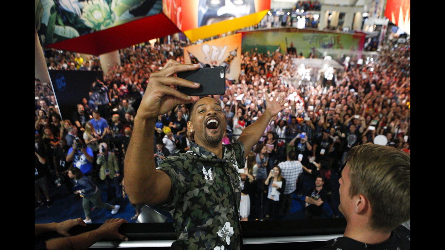Actor Will Smith takes a video of the crowd during a "Suicide Squad" signing during the third day of Comic-Con International 2016 in San Diego.