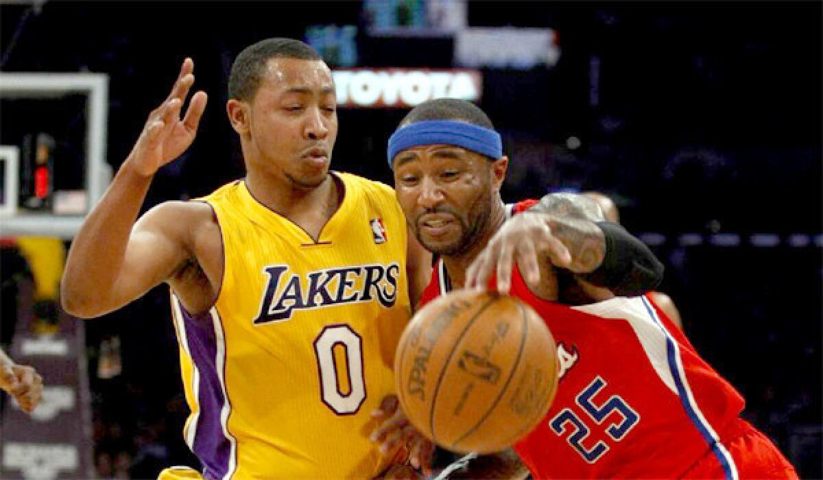 Andrew Goudelock defends against the Clippers' Mo Williams during a game last season.