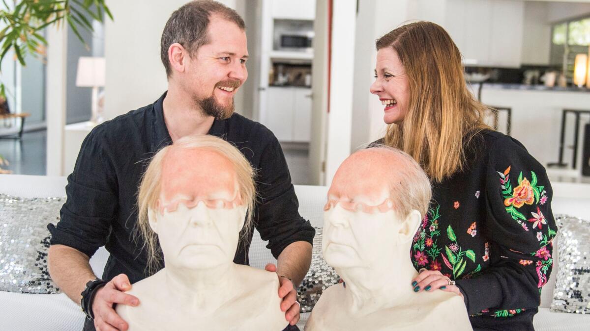 Love Larson, left and Eva von Bahr, right, hold face casts of actor Rolf Lassgård from the show "A Man Called Ove."