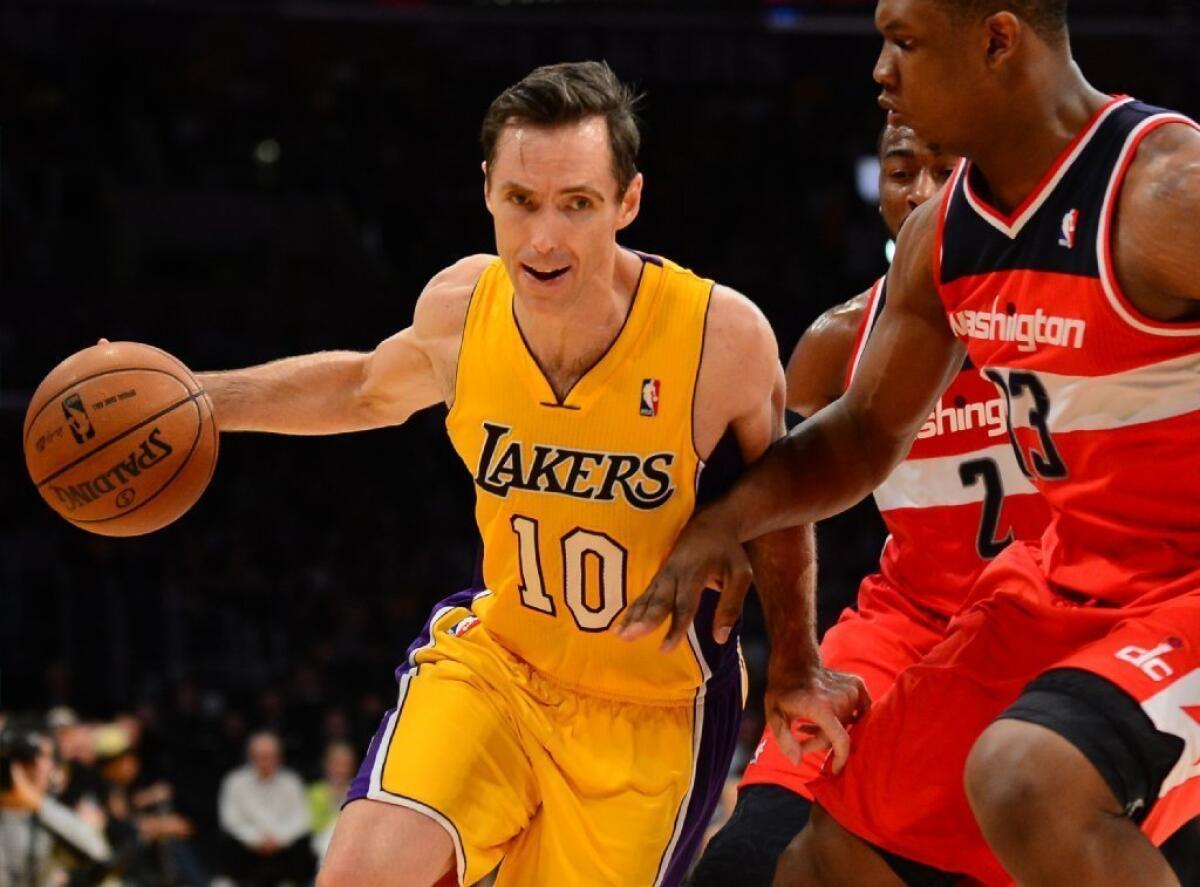 Steve Nash drives against Kevin Seraphin and John Wall of the Washington Wizards during a game last spring.