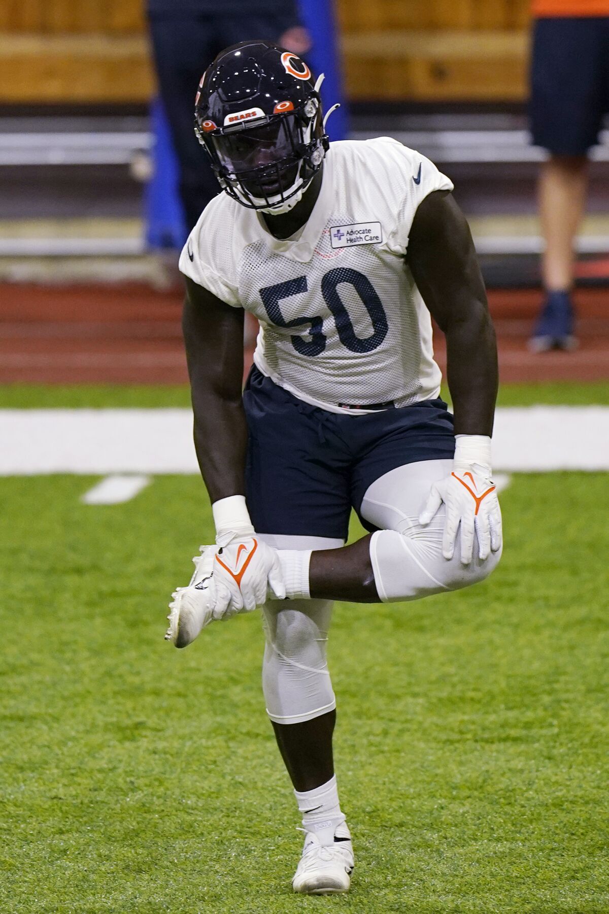 Chicago Bears linebacker Jeremiah Attaochu stretches at the NFL football team's practice facility in Lake Forest, Ill., Wednesday, June 8, 2022. (AP Photo/Nam Y. Huh)