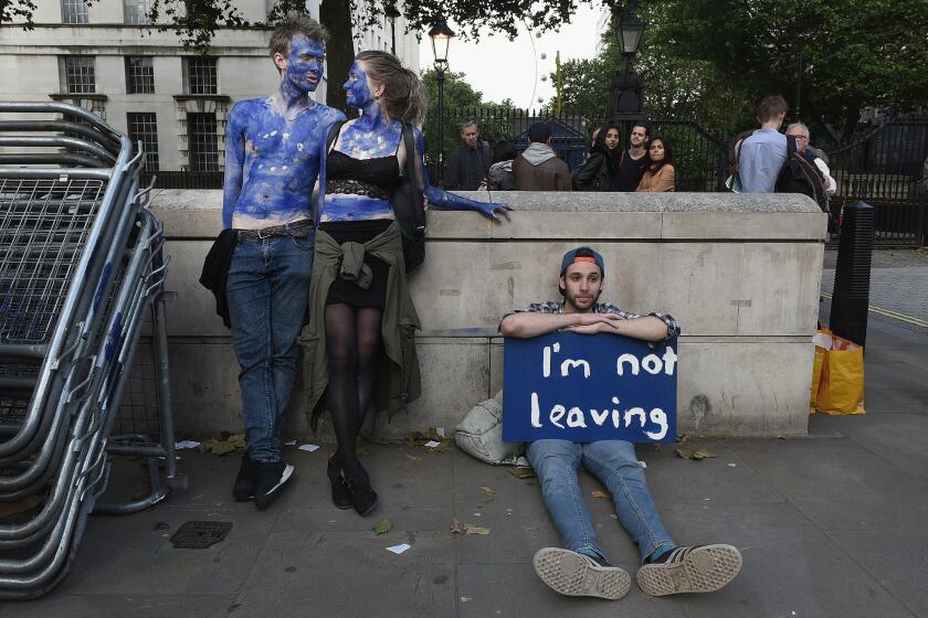 A young couple painted as EU flags protest outside Downing Street in London. They opposed Britain's decision to leave the EU.