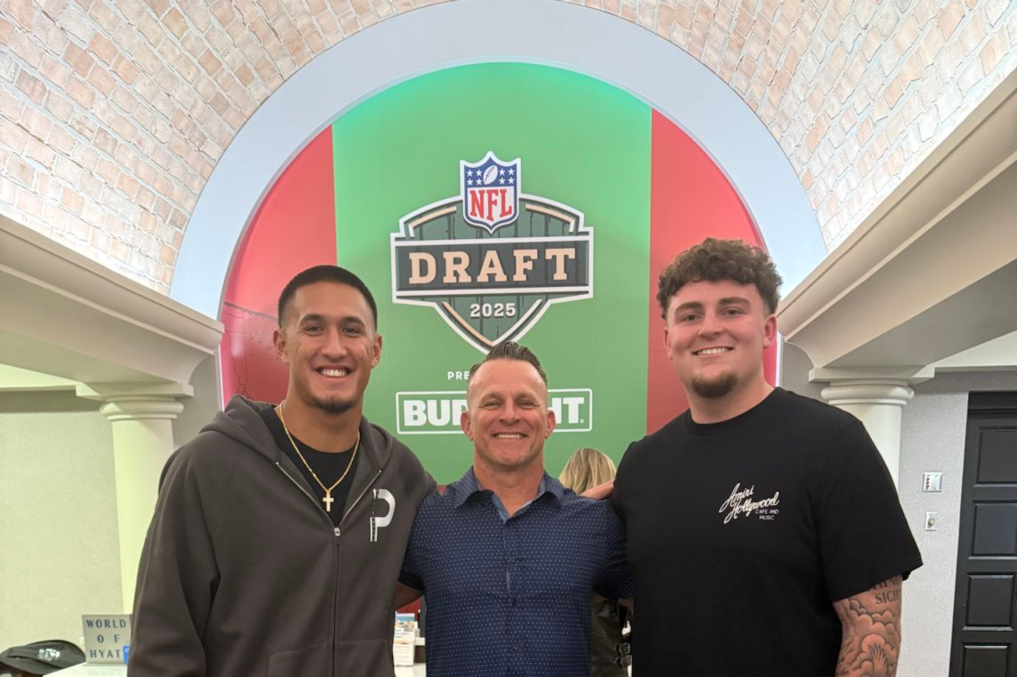 Former Servite coach Troy Thomas, center, stands with wide receiver Tetairoa McMillan, left, and Mason Graham.