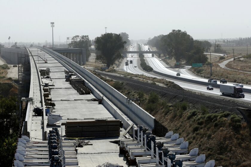 FILE - In this Oct. 9, 2019, file photo, is the high-speed rail viaduct paralleling Highway 99 near Fresno, Calif. The federal government has reached an agreement to restore nearly $1 billion in funding for California's troubled bullet train. Gov. Gavin Newsom announced Thursday night, June 10, 2021, that the U.S. Department of Transportation finalized settlement negotiations to restore money for the high-speed rail project that the Trump administration revoked in 2019. (AP Photo/Rich Pedroncelli, File)