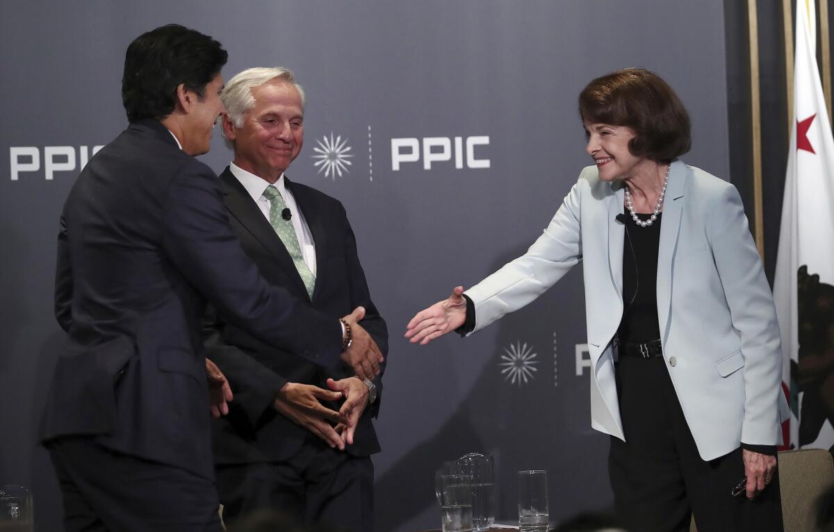 State Sen. Kevin de Leon and U.S. Sen. Dianne Feinstein after their debate Wednesday. They are joined by moderator Mark Baldassare.