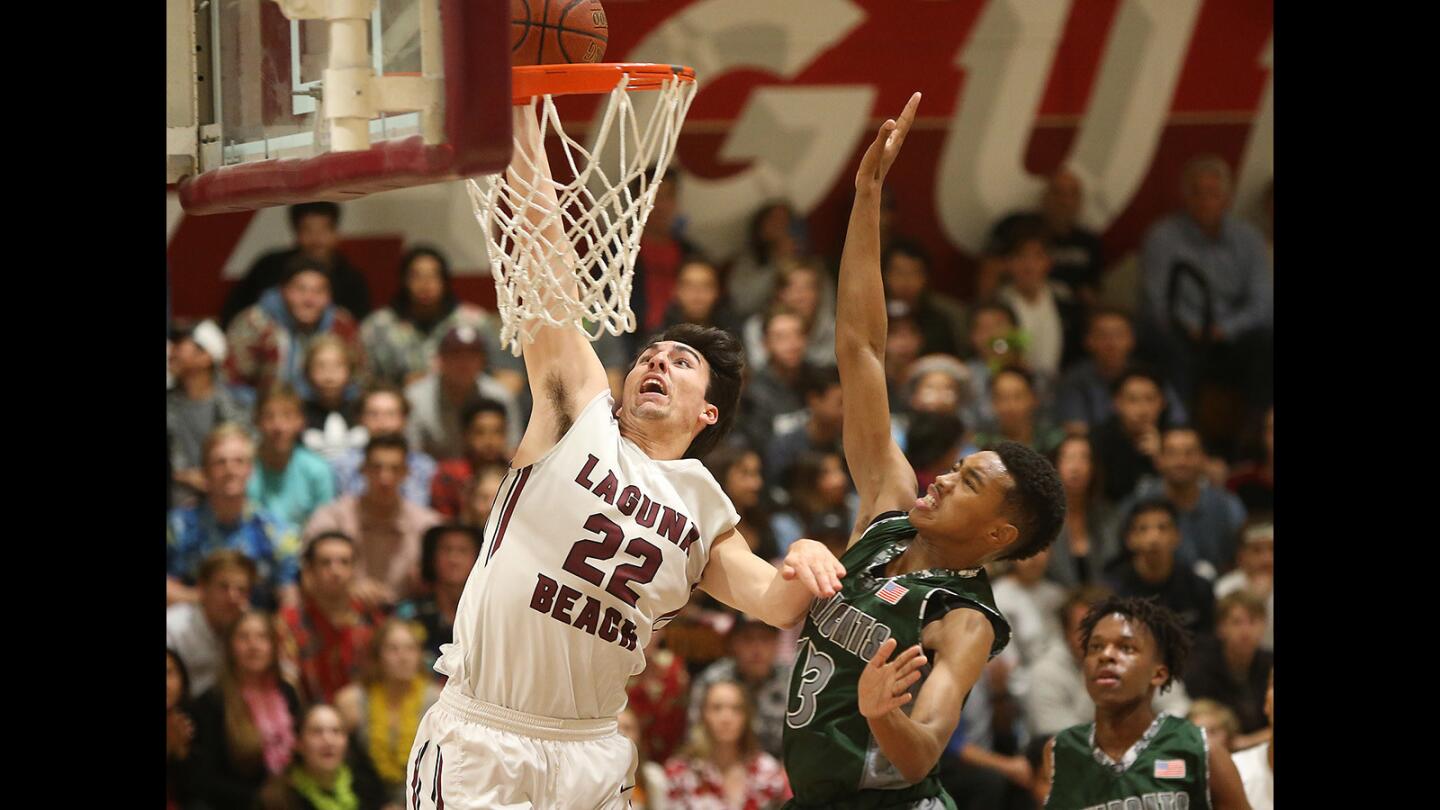 Laguna's Blake Burzell drives the basket after a breakaway for a layup during second round of the CIF Southern Section Division 3AA playoffs against Twentynine Palms on Friday at Laguna Beach High.