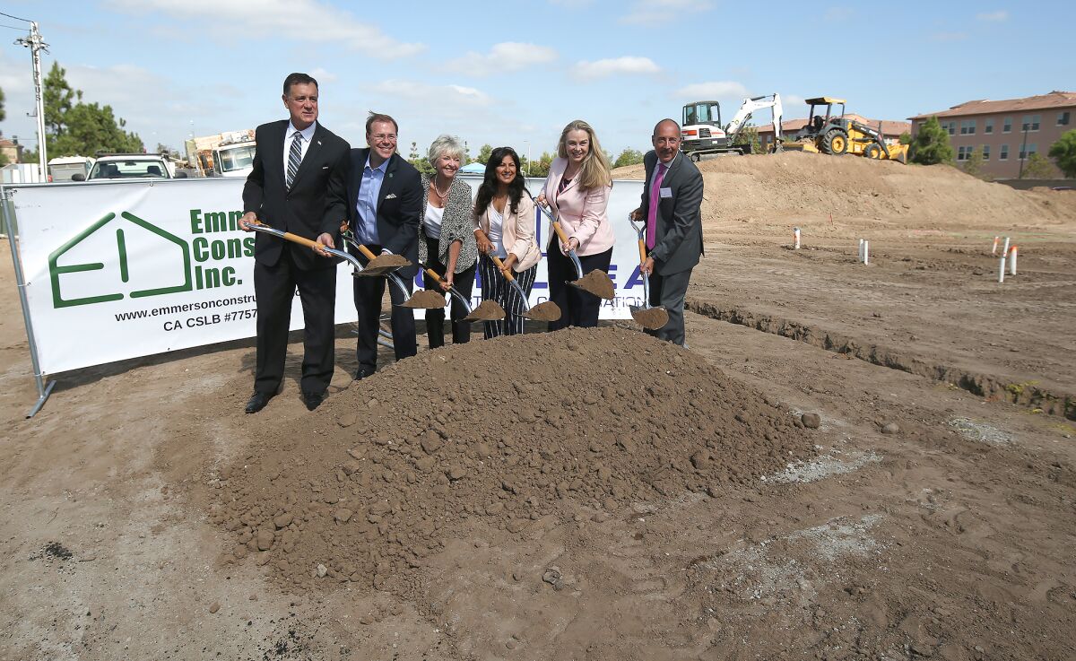 From left, Orange County Supervisor Donald Wagner, Irvine Councilman Michael Carroll, Mayor Christina Shea, Councilwoman Farrah Khan, Councilwoman Melissa Fox and Mark Asturius of the Irvine Land Trust gather for a ceremonial ground breaking for an affordable housing development. The Salerno tract will open in fall 2020.
