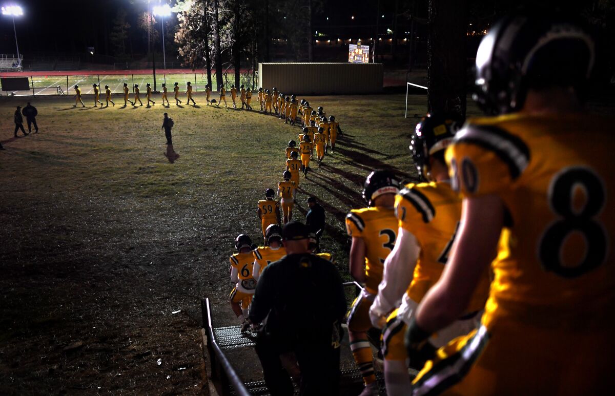 The Paradise football team makes it way to the field before a playoff game.