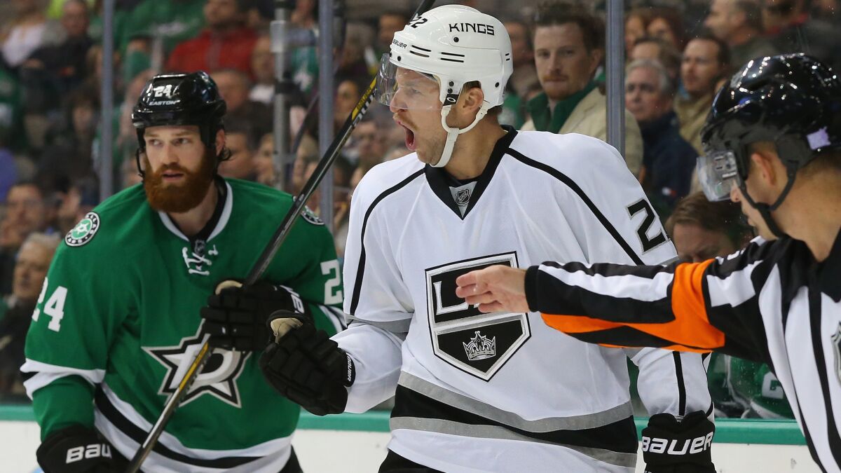 Kings forward Trevor Lewis, center, celebrates in front of Dallas Stars defenseman Jordie Benn after scoring a short-handed goal during the second period of the Kings' 3-1 win Tuesday.