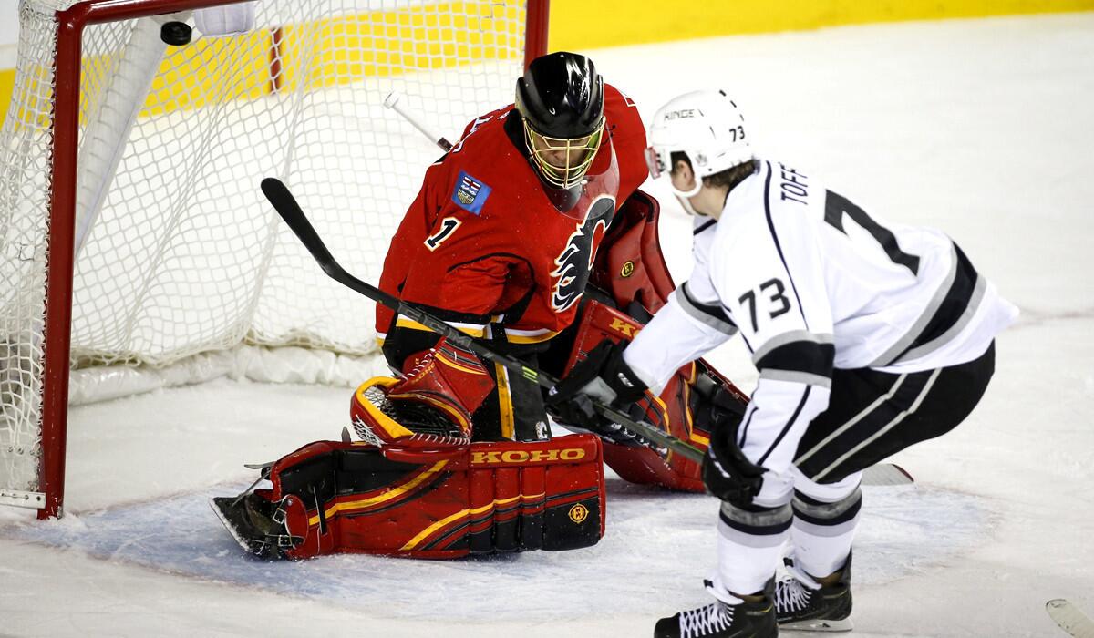 Kings forward Tyler Toffoli scores against Flames goaltender Jonas Hiller in the second period Monday night in Calgary.