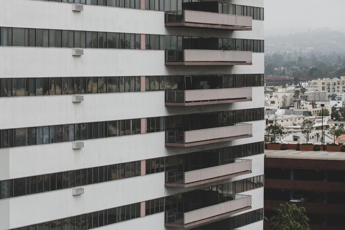 A modern apartment building with balconies and L.A. in background