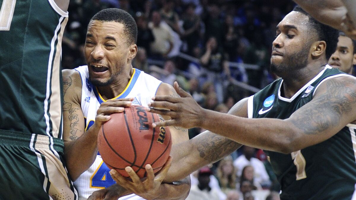 UCLA's Norman Powell, left, is fouled by UAB's Denzell Watts during the Bruins' 92-75 win in the third round of the NCAA tournament South Regional on March 21, 2015.