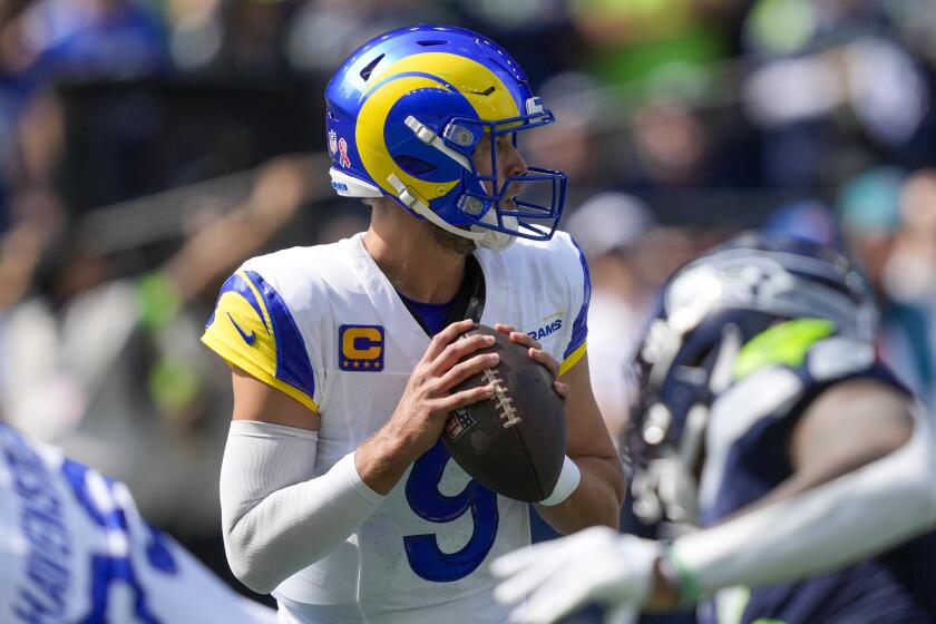 Los Angeles Rams quarterback Matthew Stafford looks to pass against the Los Angeles Rams.