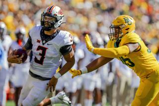 Oklahoma State quarterback Spencer Sanders (3) rushes past Baylor linebacker Tyrone Brown (36) during the first half of an NCAA college football game in Waco, Texas, Saturday, Oct. 1, 2022. (AP Photo/Gareth Patterson)