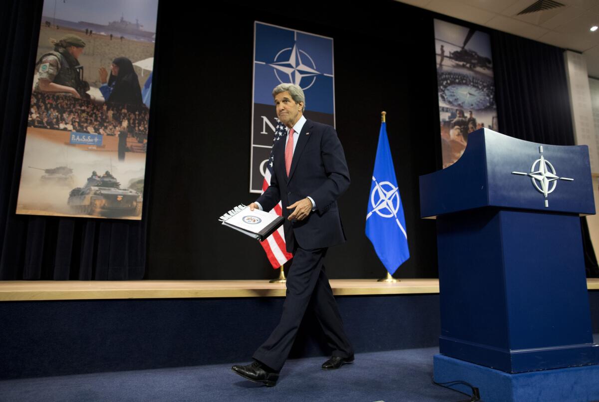 U.S. Secretary of State John F. Kerry finishes up at a news conference at NATO headquarters in Brussels.