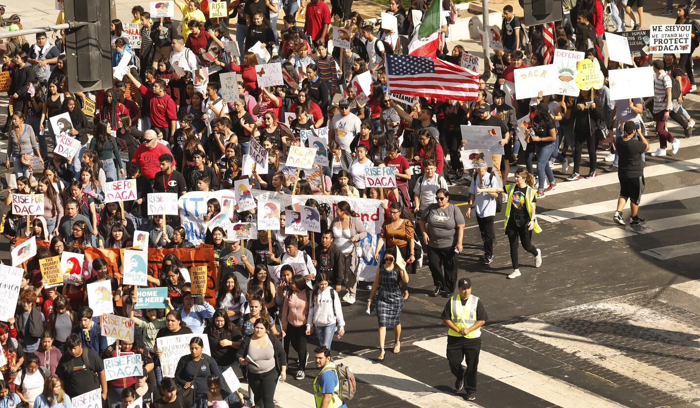 Demonstrators march from the federal building in downtown Los Angeles to MacArthur Park Tuesday morning.