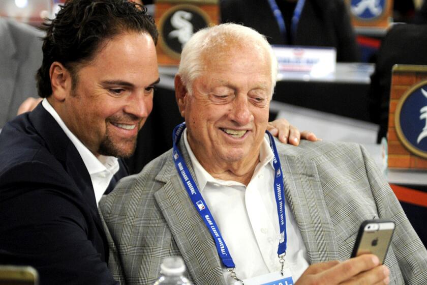 Former Dodgers catcher Mike Piazza, left, and manager Tom Lasorda take a picture before the 2014 amateur draft.