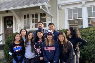 Laura Castañeda poses with students and staff in front of La Casa Cultural Latina on the campus of the University of Illinios at Chamapign-Urbana in 2023.