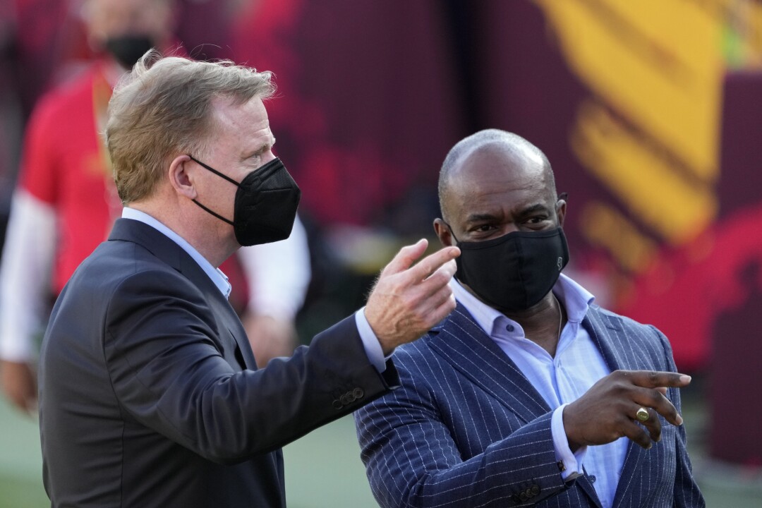 Roger Goodell and NFL Players Assn. executive director DeMaurice Smith talk before Super Bowl LV.