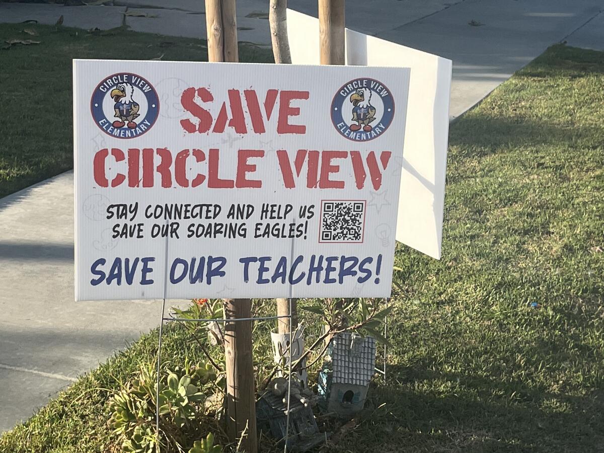 A sign supporting Circle View Elementary School is seen in a front yard close to the school.