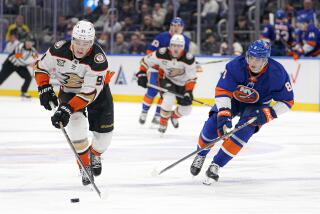 Anaheim Ducks center Leo Carlsson (91) is pursued by New York Islanders defenseman Noah Dobson (8) during the second period of an NHL hockey game in Elmont, N.Y., Wednesday, Dec. 13, 2023. (AP Photo/Peter K. Afriyie)