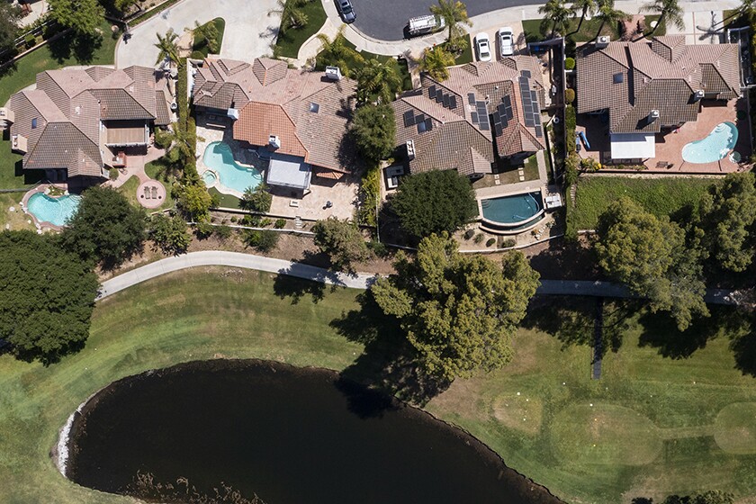Aerial photo of several homes, some with outdoor swimming pools