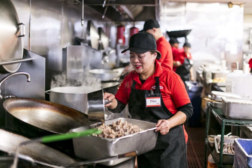Chef Pilar Araula from Bohol, a province of the Philippines, in the country’s Central Visayas region, cooks her specialties in the open kitchen at Arko Foods International.