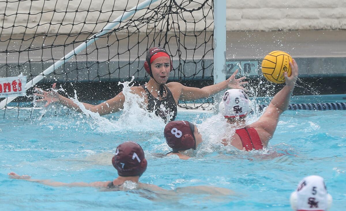 Laguna Beach goalie Lauren Schneider goes head-to-head with San Marcos attacker Reagan McEchen (6) during Friday's match.