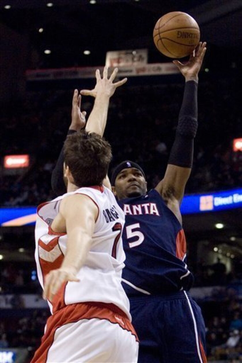 Atlanta Hawks' Josh Smith, right, scores over Toronto Raptors' Andrea Bargnani during the second half of an NBA basketball game in Toronto on Tuesday, April 7, 2009. (AP Photo/The Canadian Press, Chris Young)