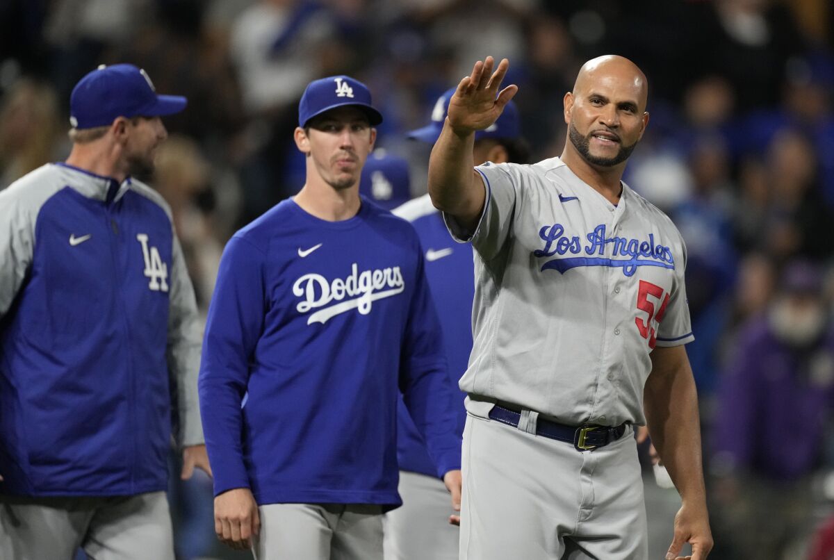 The Dodgers' Albert Pujols waves to fans after the 10th inning of a game at Colorado on Sept. 21, 2021.