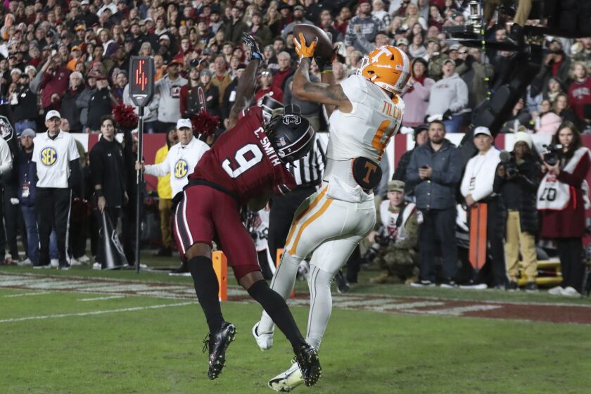 Tennessee wide receiver Cedric Tillman (4) makes a catch over South Carolina defensive back Cam Smith (9) for a 3-yard touchdown during the first half of an NCAA college football game Saturday, Nov. 19, 2022, in Columbia, S.C. (AP Photo/Artie Walker Jr.)