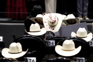 Legislators from the Institutional Revolutionary Party (PRI) placed hats painted like blood on their seats