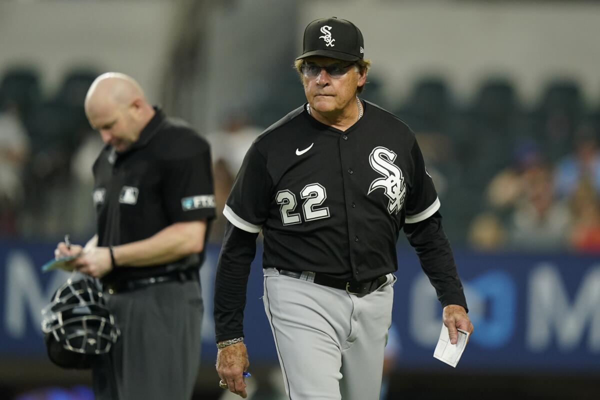 Chicago White Sox manager Tony La Russa (22) walks back to the dugout after conferring with hone plate umpire Mike Estabrook during the ninth inning of a baseball game against the Texas Rangers in Arlington, Texas, Sunday, Aug. 7, 2022. The White Sox won 8-2. (AP Photo/LM Otero)