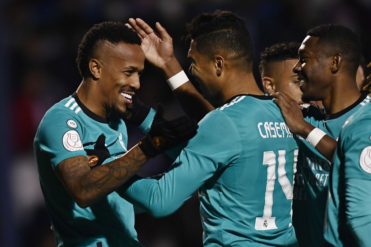 Real Madrid's Eder Militao, left, celebrates with team mates after scoring the opening goal during a Copa del Rey, round of 16, soccer match between Alcoyano and Real Madrid at El Collao stadium in Alcoy, Spain, Wednesday, Jan. 5, 2022. (AP Photo/Jose Breton)