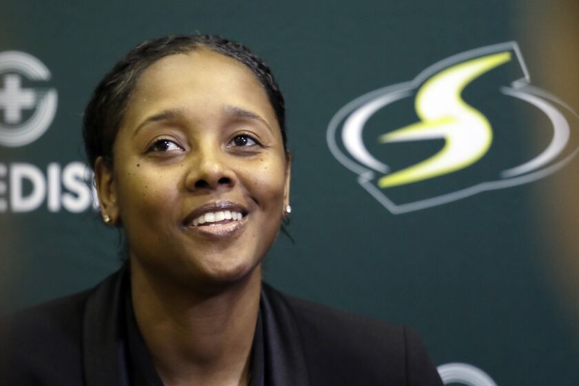 Seattle Storm assistant coach Noelle Quinn speaks with media members at the basketball team's media day Monday, May 13, 2019, in Seattle. The Storm is the defending WNBA champion. (AP Photo/Elaine Thompson)
