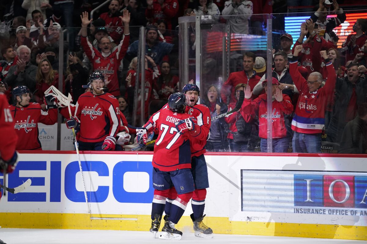 Washington Capitals left wing Alex Ovechkin, right, celebrates his second period goal against the Carolina Hurricanes with teammate T.J. Oshie, Thursday, March 3, 2022, in Washington. (AP Photo/Evan Vucci)