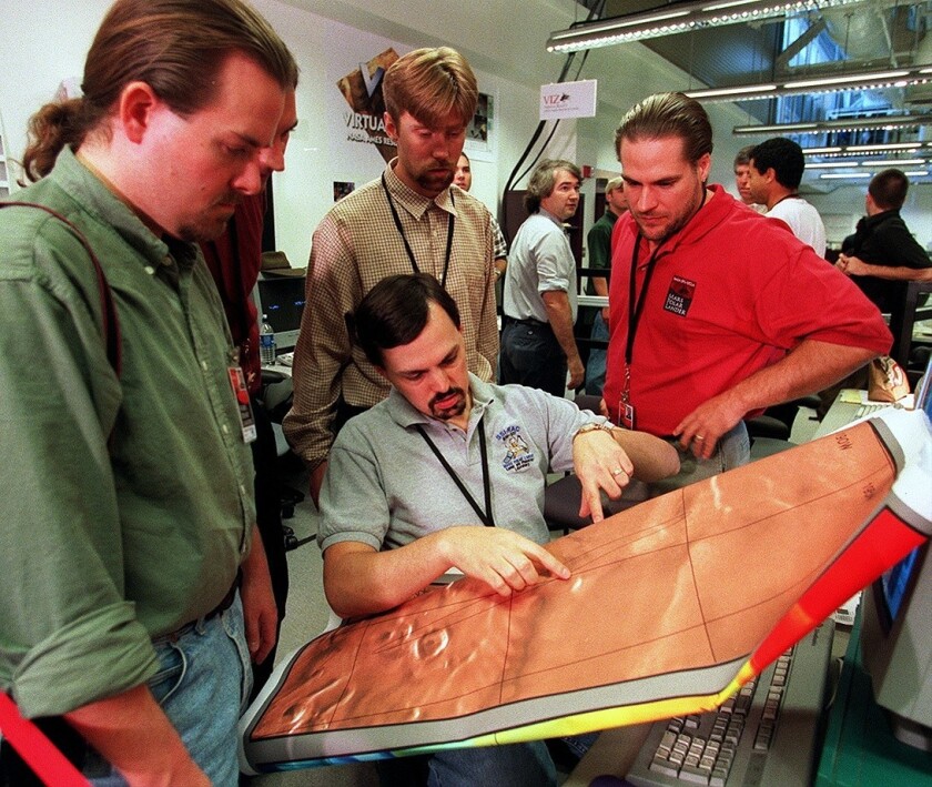 Typical public employees? UCLA scientist Mark Lemmon (holding map) and other planetary scientists at UCLA examining a map of Mars in 1999.