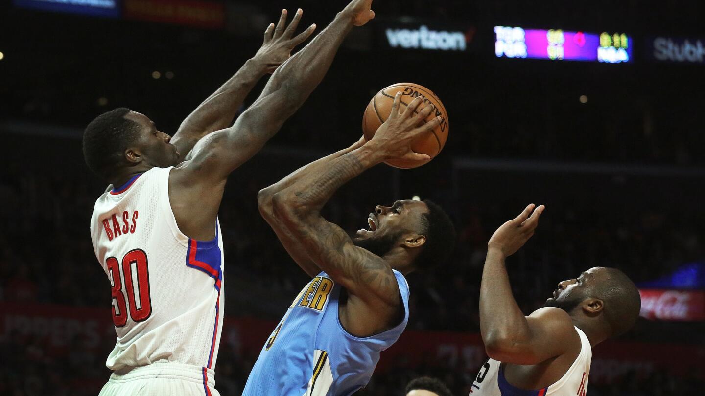 Nuggets guard Will Barton looks to score between Clippers forward Brandon Bass (30) and guard Raymond Felton during the second half.