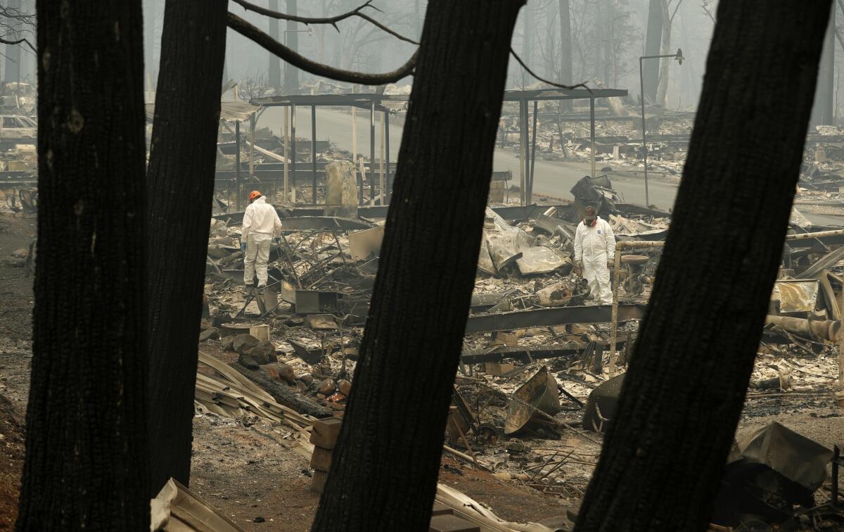 Search-and-rescue workers look for human remains at a trailer park engulfed by the Camp fire on Tuesday.