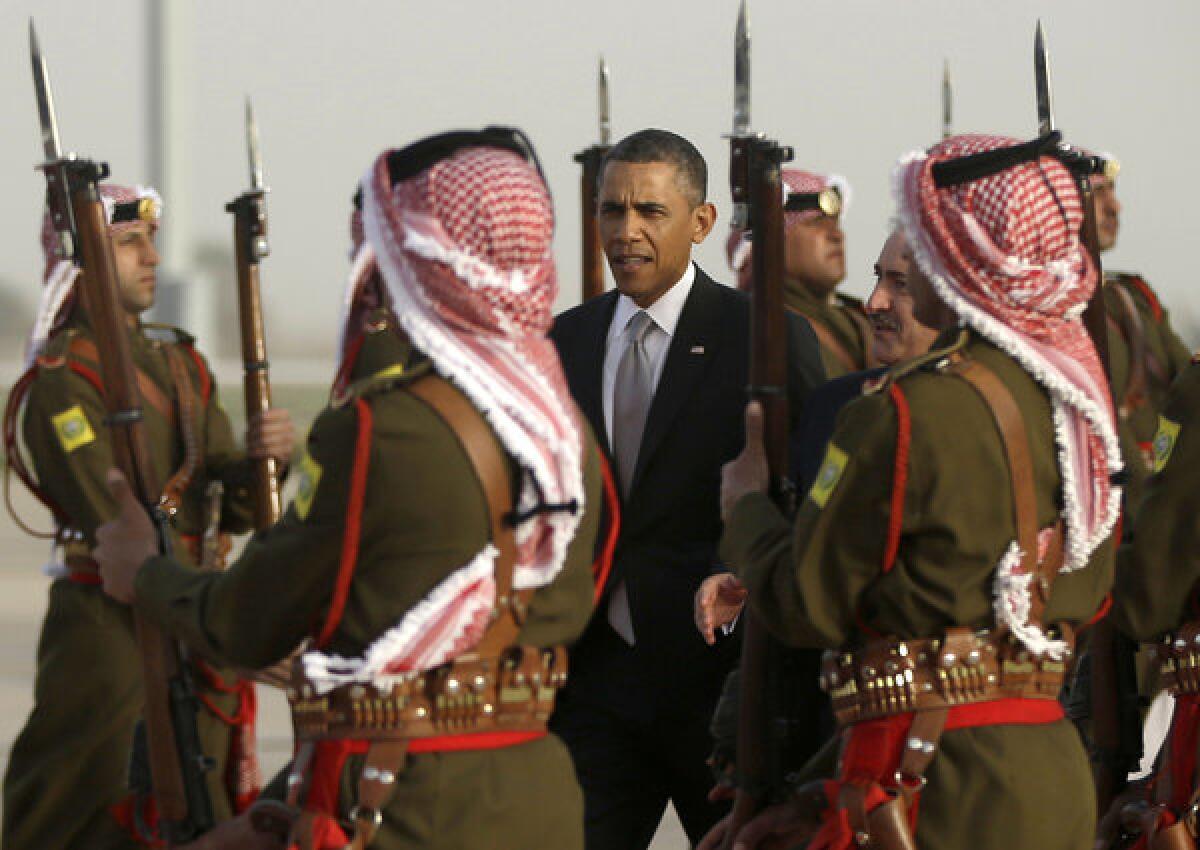 President Obama walks with Jordanian Foreign Minister Nasser Judeh upon his arrival Friday at Queen Alia International Airport in Amman, Jordan.