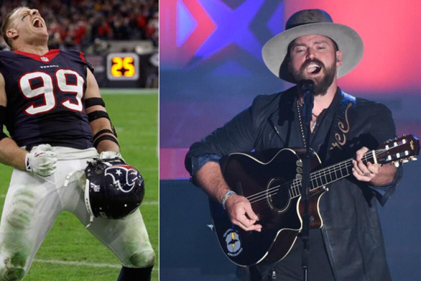 The NFL's J.J. Watt, left, did Zac Brown and his band a favor Sunday night in Milwaukee, tackling a stage-jumper during the concert. Staged or not, it's comedy.