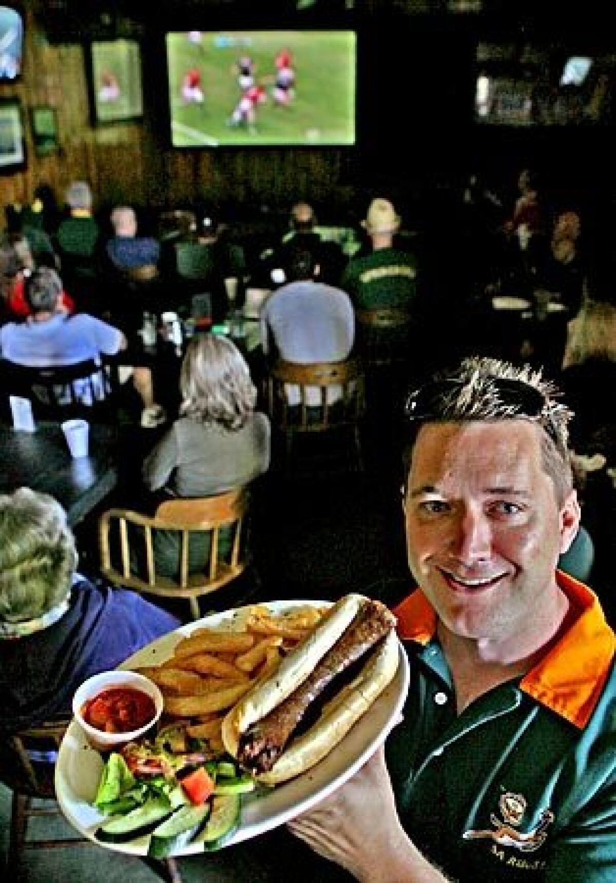 Springbok Bar & Grill owner Peter Walker displays his restaurants farmers sausage dish.
