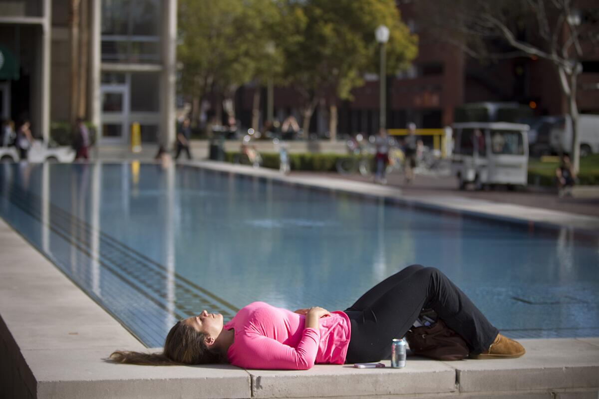 Lindsay Nieto, 25, a first-year master's program candidate, takes advantage of sunny skies and warm temperatures at USC on Wednesday.