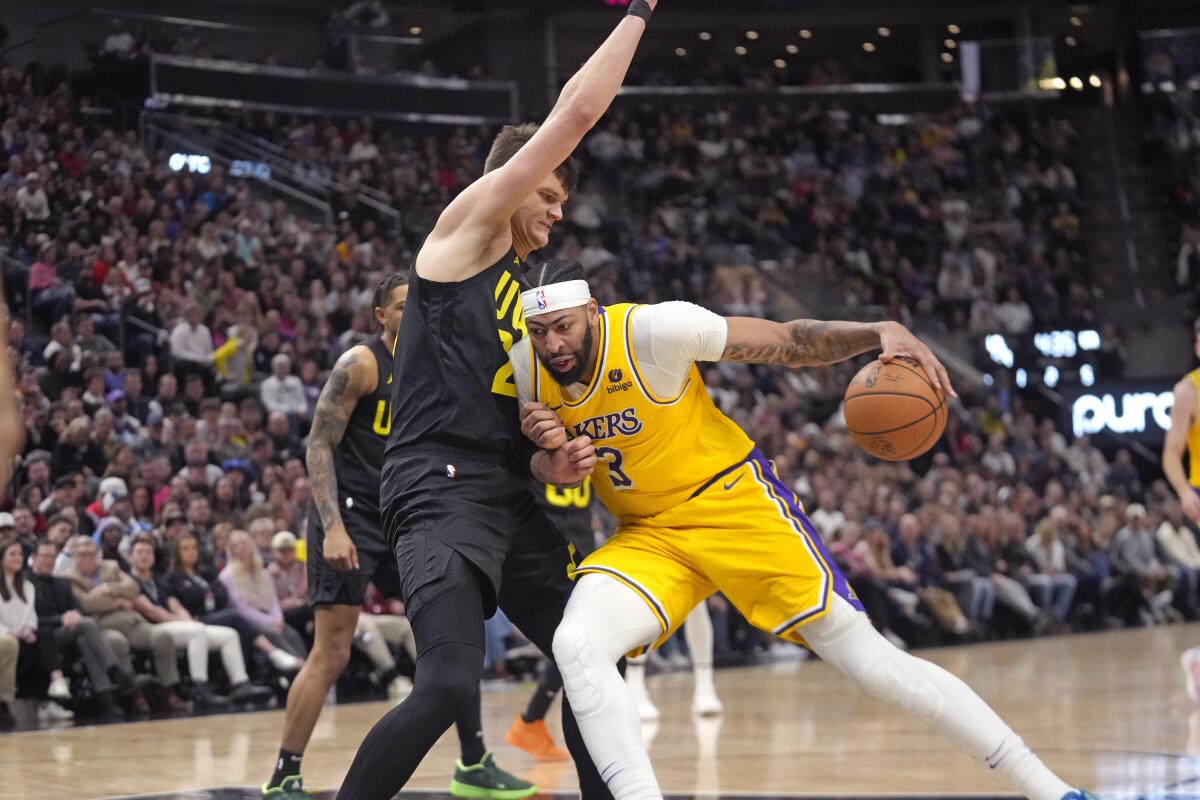 Utah Jazz center Walker Kessler defends against Anthony Davis in the first half.